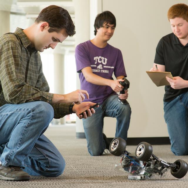 students working with a robot