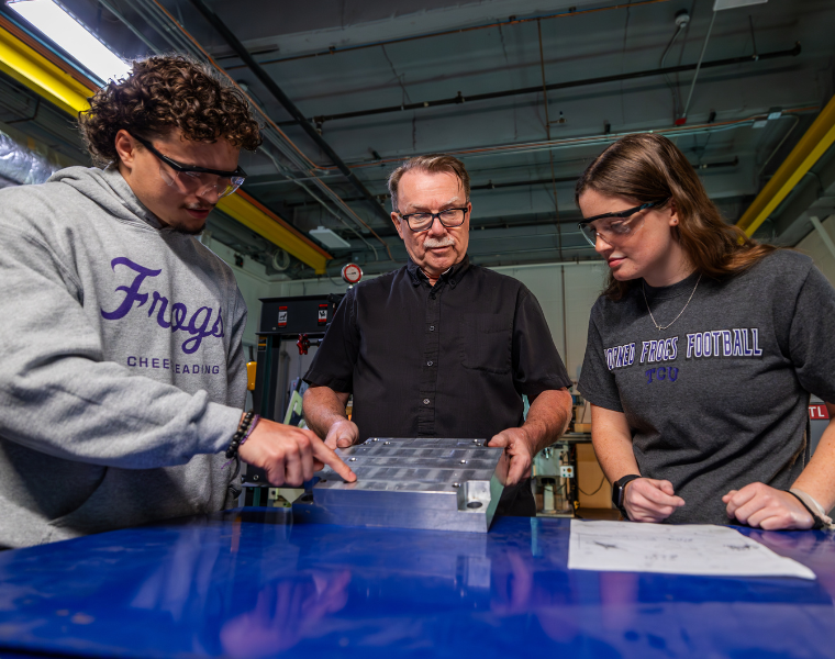 students working on machinery