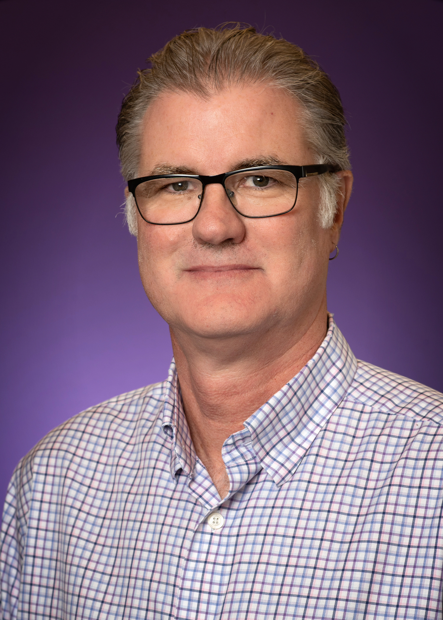 Mike Slattery's headshot on a purple background.