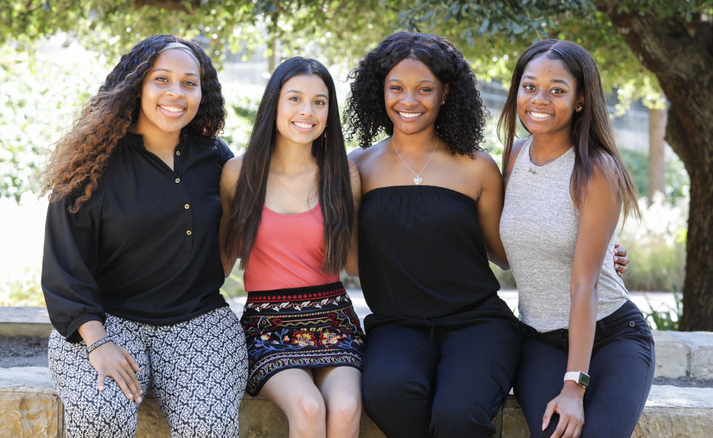 Four members of Molding Melanin Magic grouped together outside