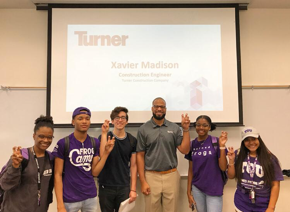 STEM Scholars in front of a projector screen with the words Turner Xavier Madison Construction Engineer on it