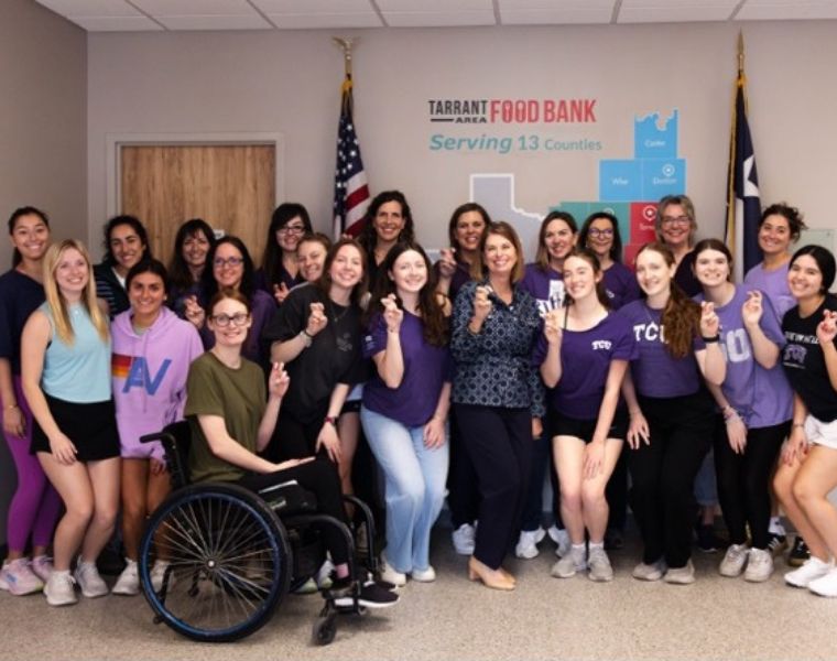 Julie Butner poses with current TCU nutritional sciences students and faculty.