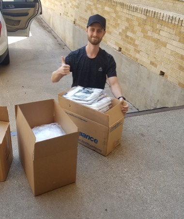 Michael Ward loading PPE supplies onto a truck