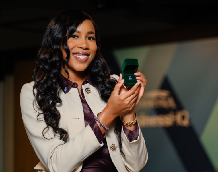 Yvonne Igodan holds lapel pin in case.