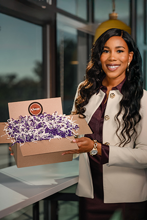 Yvonne Igodan holding box of lapel pins.