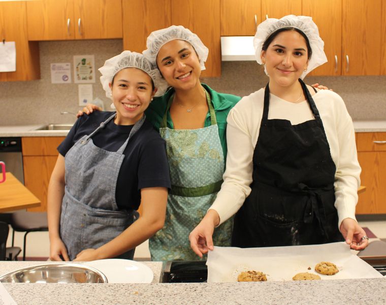 Three students pose with their finished baked good.