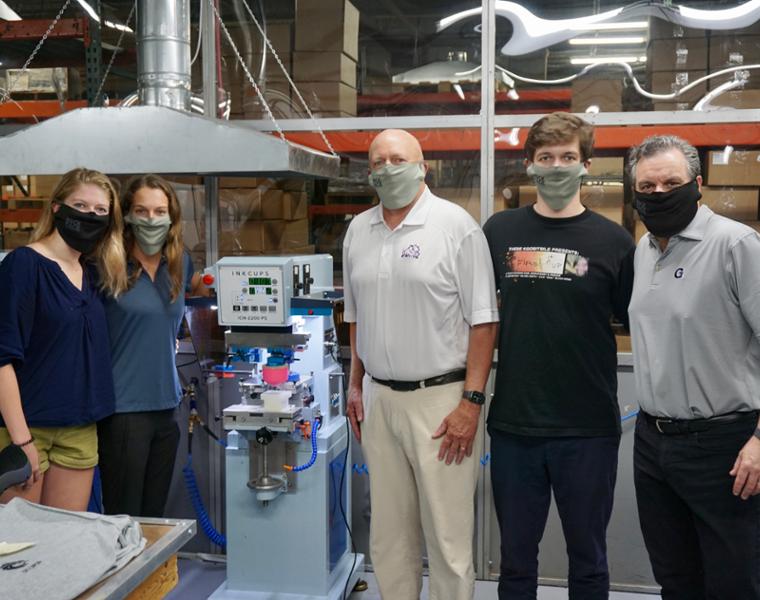 photo of Elizabeth Trexler and family in a production facility
