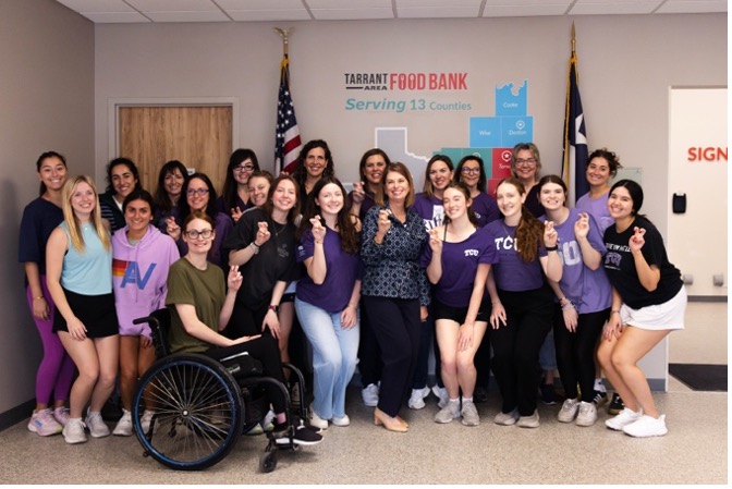 Julie Butner poses with current TCU nutritional sciences students.