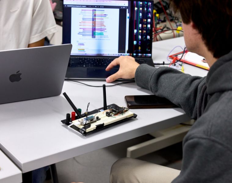 Engineering students make a circuit board.